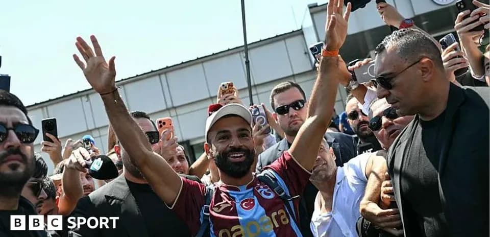 Player waving to fans during arrival at venue