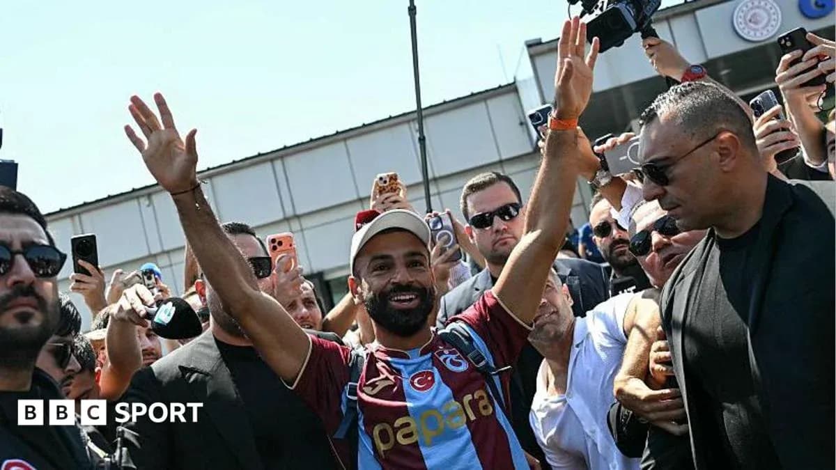 Player waving to fans during arrival at venue