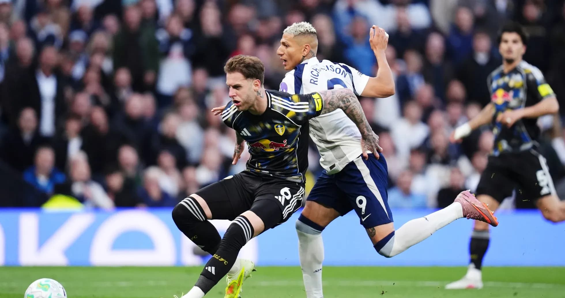 Leeds player tackled by Tottenham player