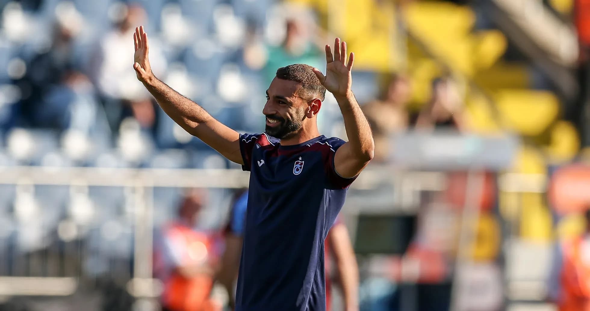 Player waving to fans during warm-up session