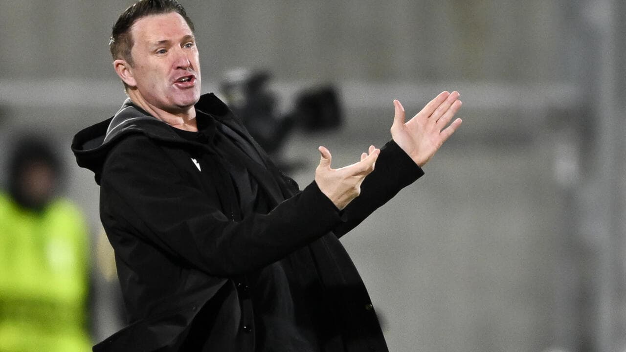 Coach giving instructions from the sidelines