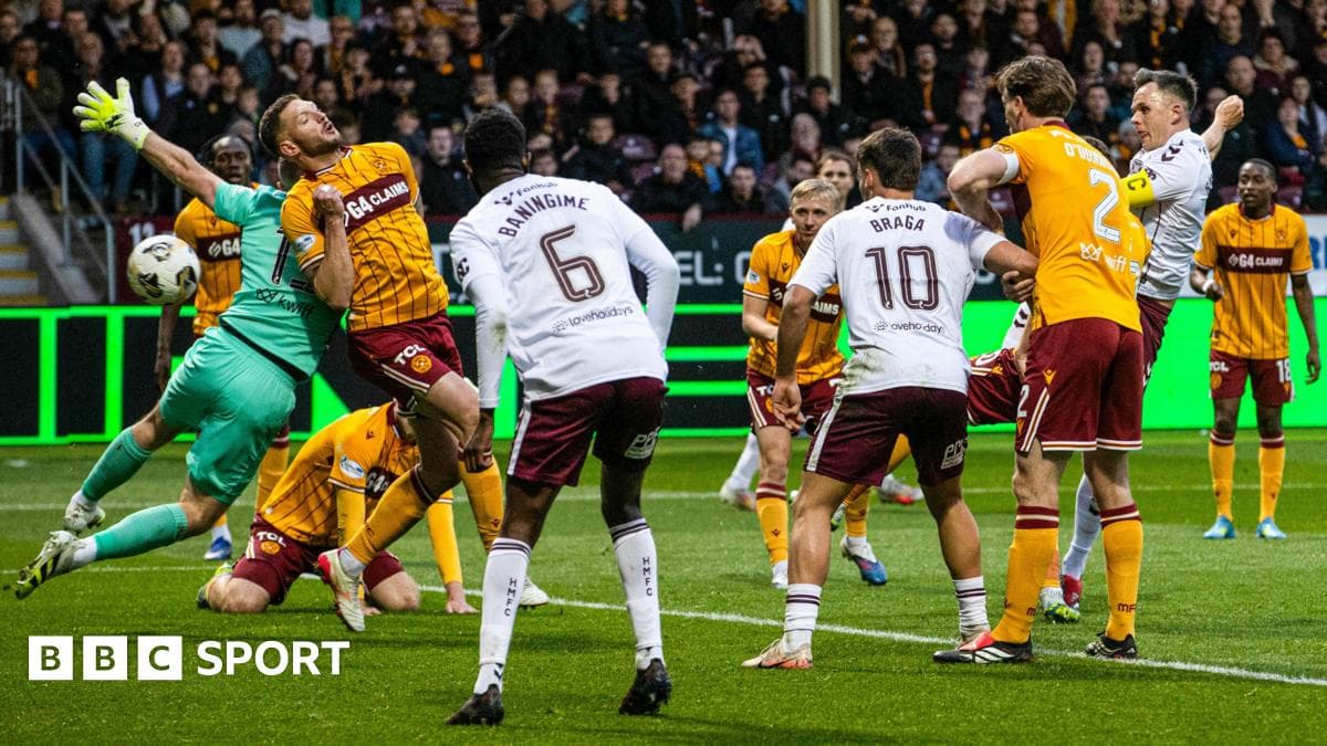 Goalkeeper attempting a save amidst player crowd