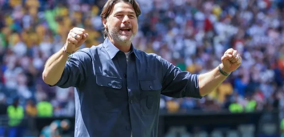Coach celebrating enthusiastically during match