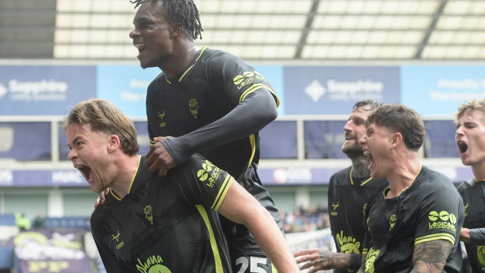 Players celebrating a goal during a match