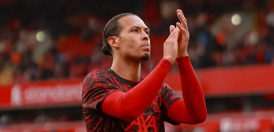 Player applauding fans in Liverpool jersey at stadium