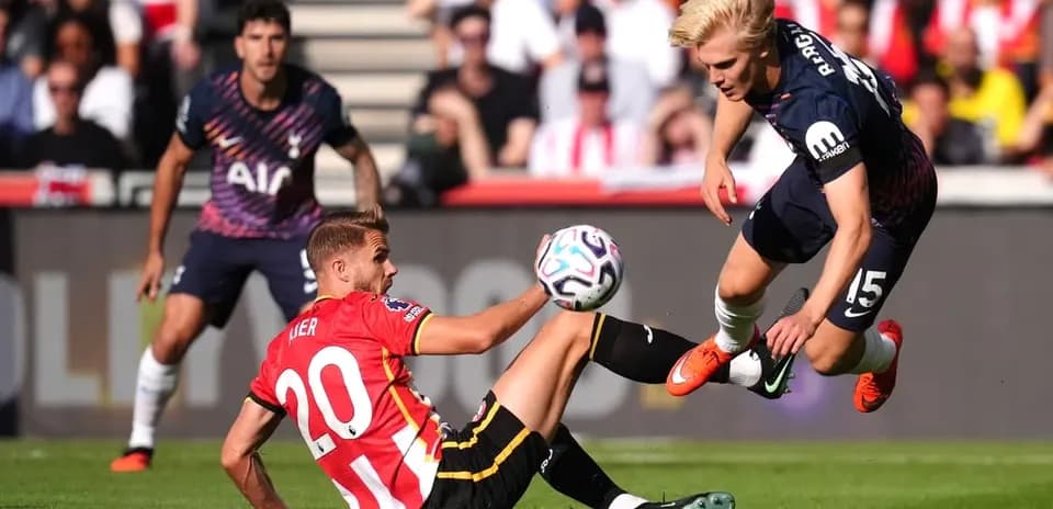 Player tackling another player during football match