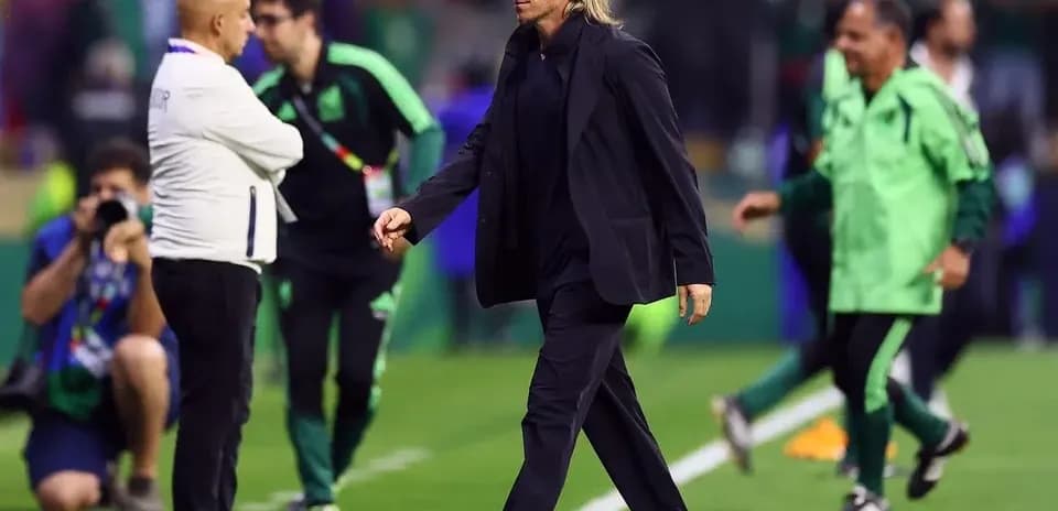 Coach walking past staff on the field