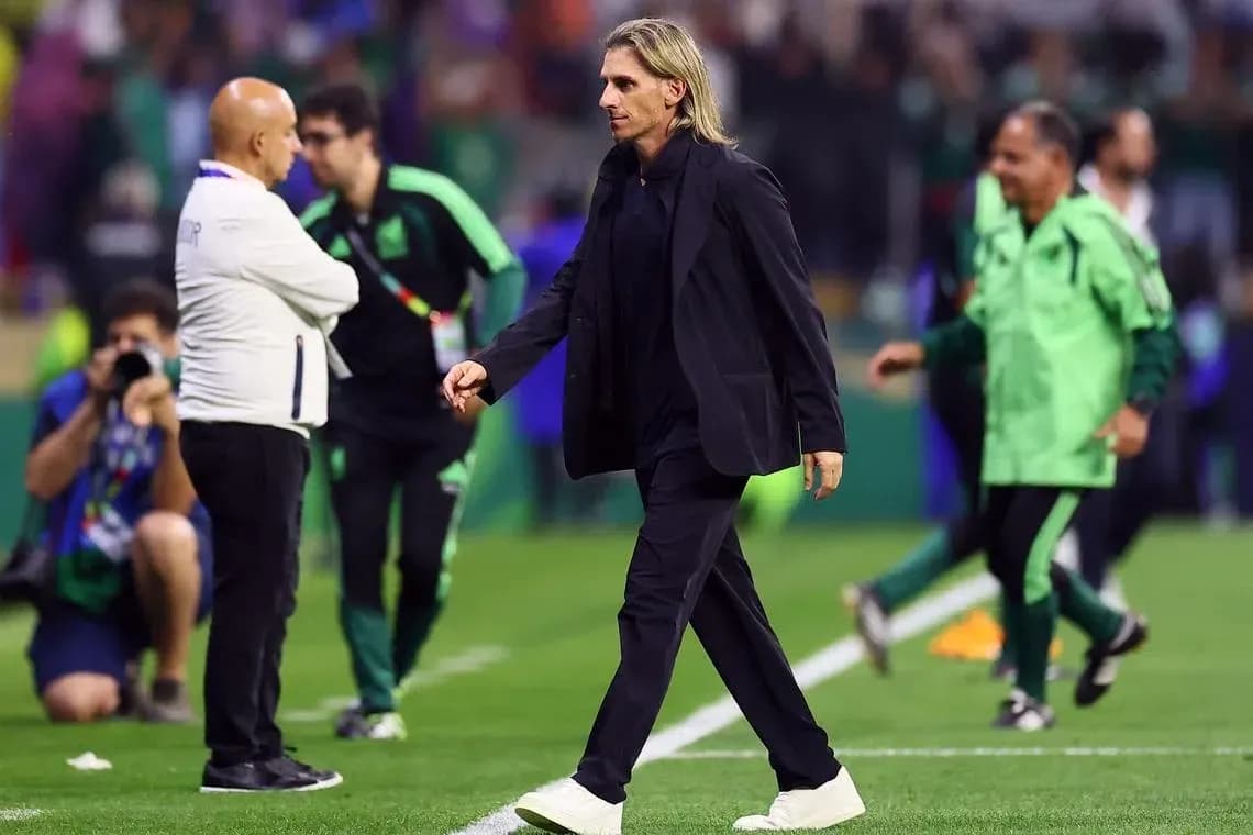 Coach walking past staff on the field