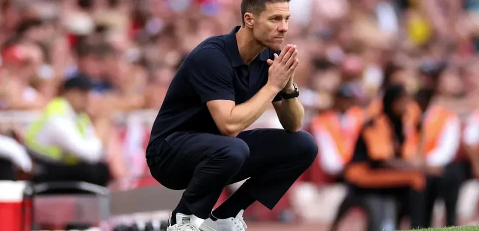 Coach crouching on sideline during match