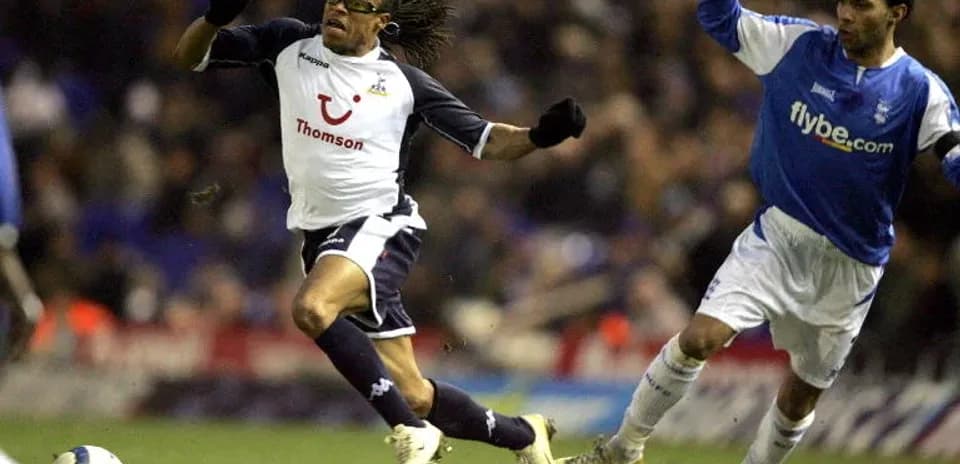 Player evading opponent during a football match