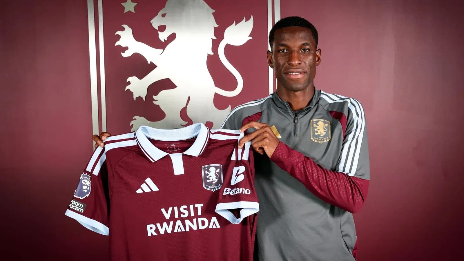 Player holding Aston Villa jersey during unveiling