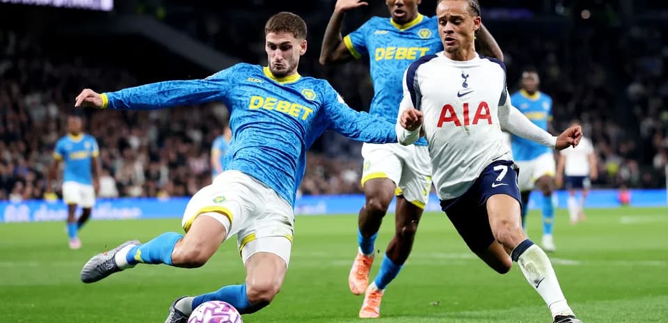 Wolves player challenges Tottenham forward during match
