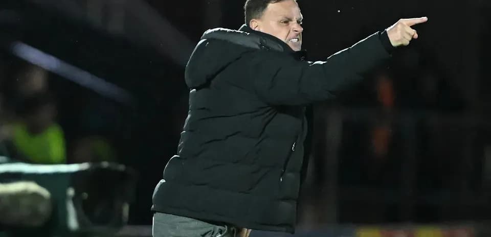 Coach directing players from the sidelines during match