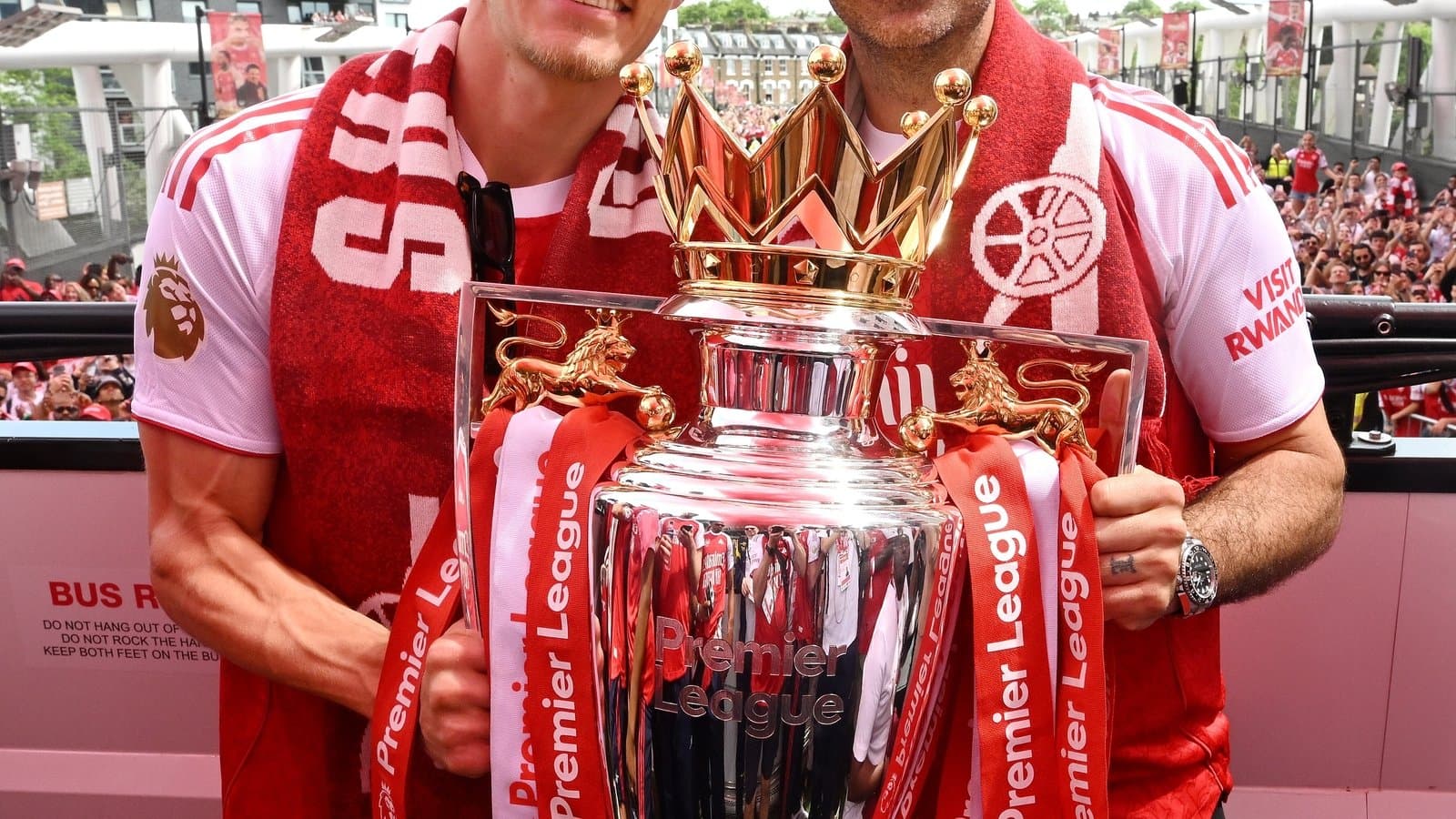 Players celebrating with Premier League trophy during parade