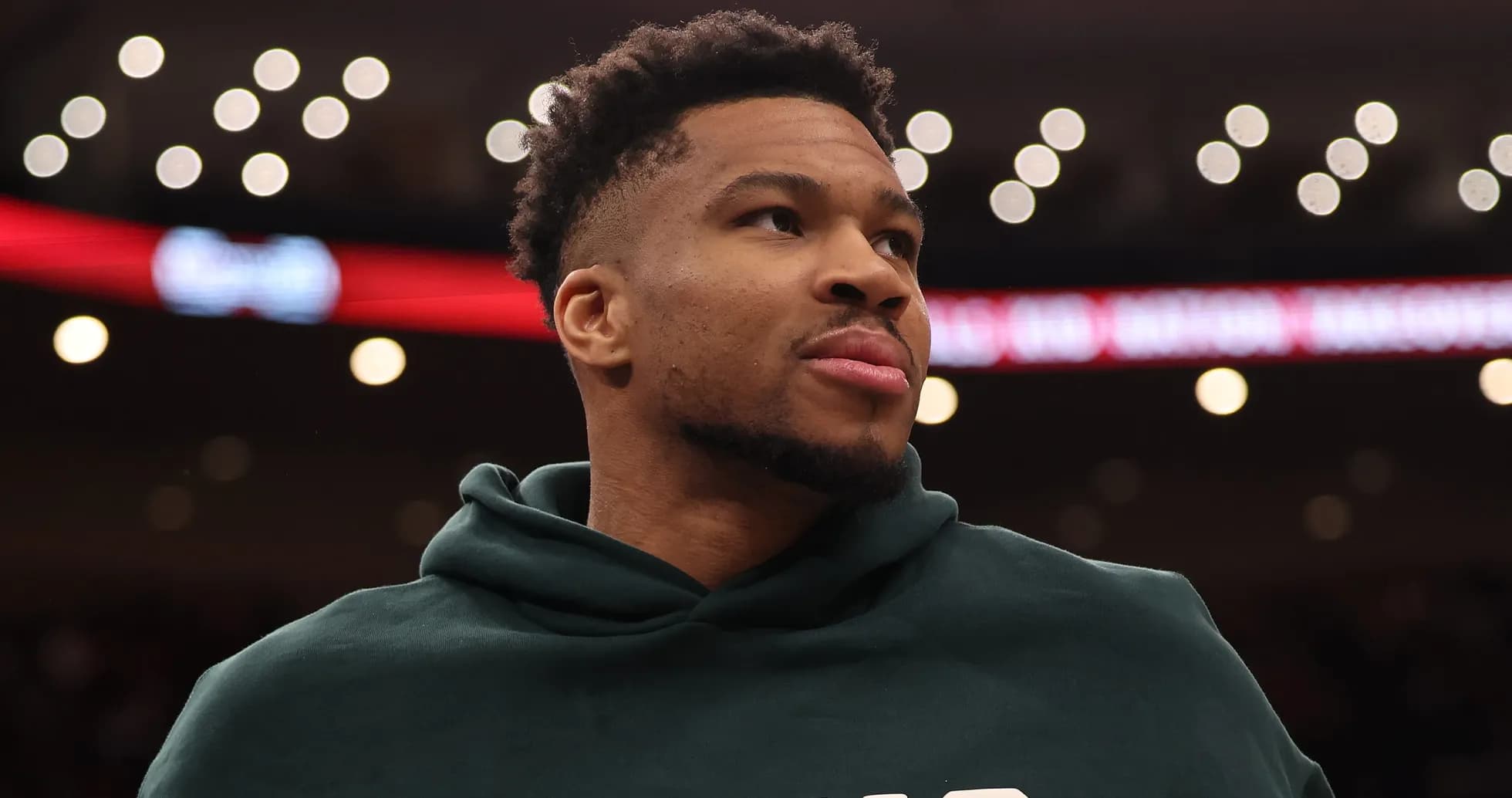 Player wearing hoodie during basketball game warm-up