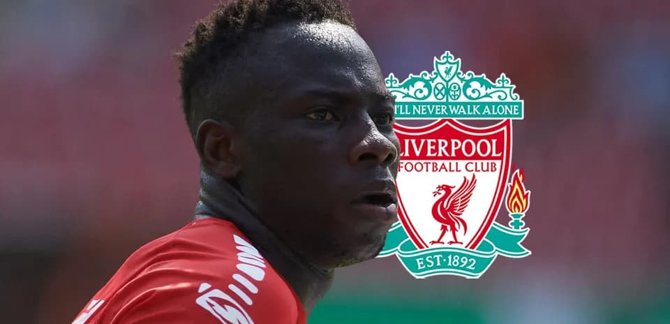 Player in Liverpool kit with club logo background