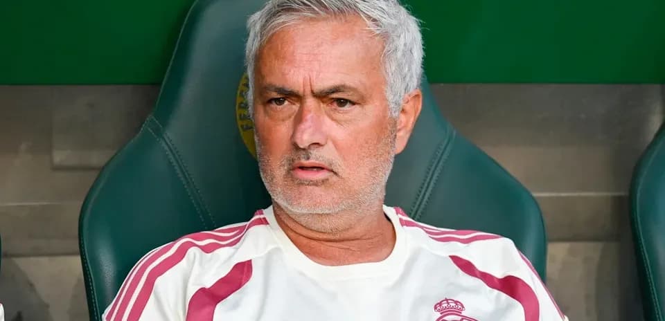 Coach seated on bench during match preparation