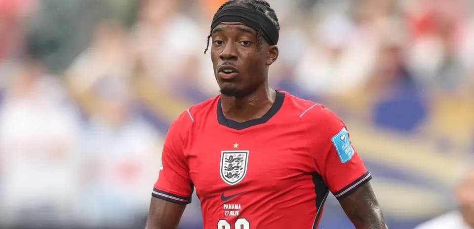 Player in red England kit during match action