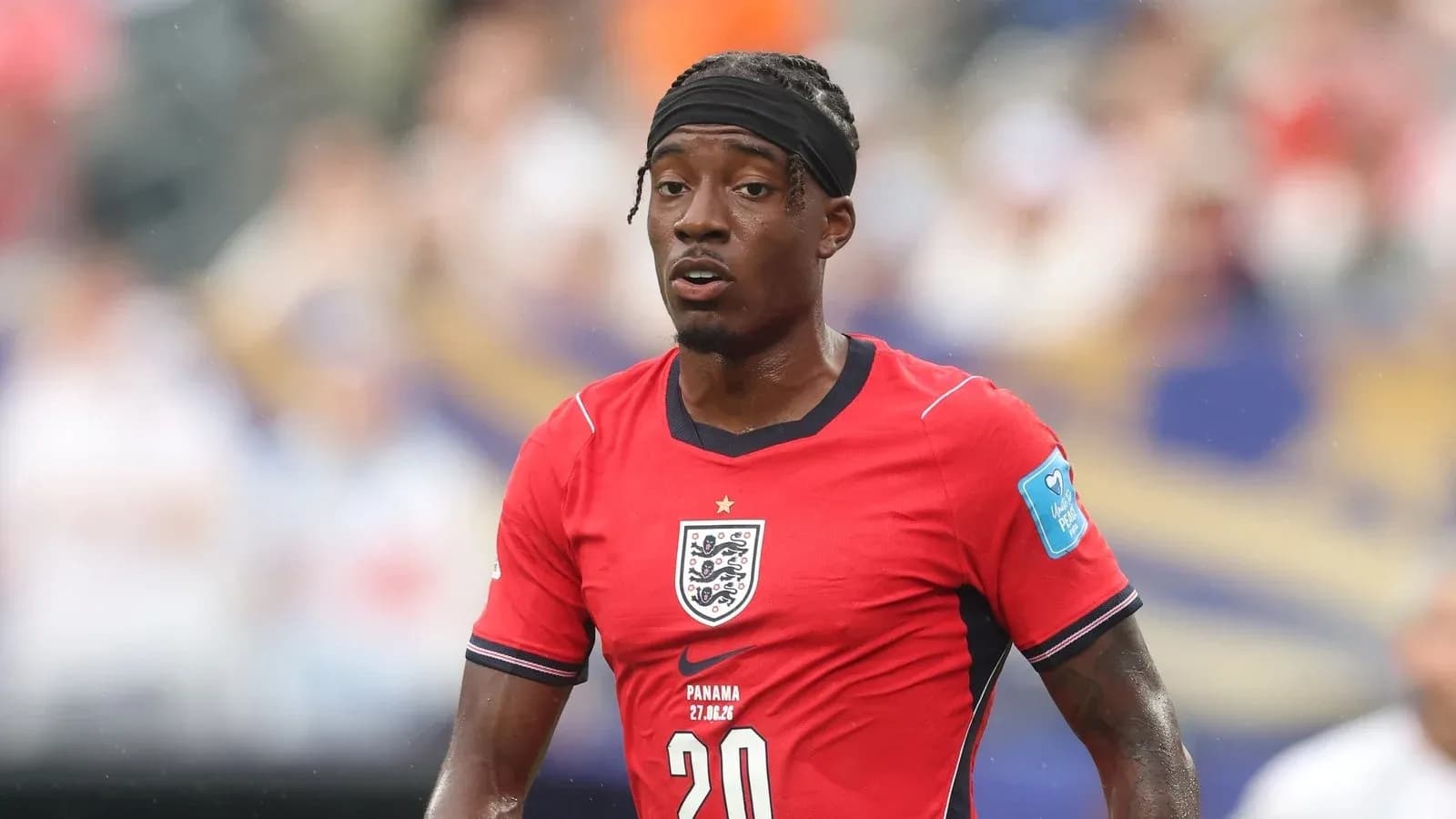Player in red England kit during match action