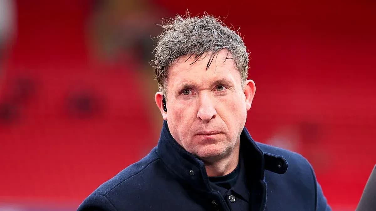 Man in a coat with earpiece at stadium