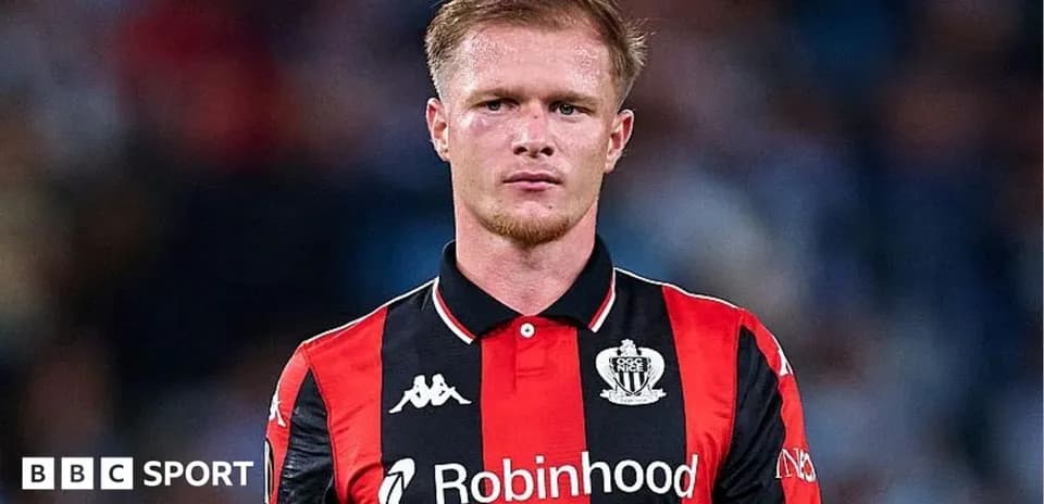Player in black and red jersey during match
