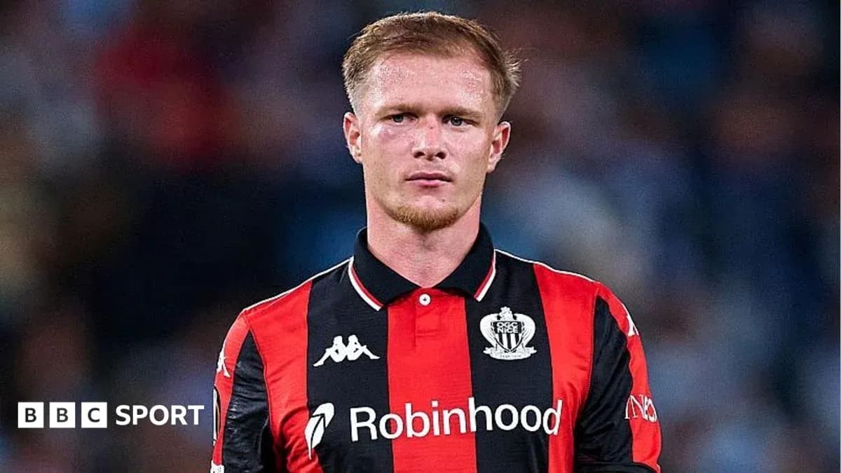 Player in black and red jersey during match