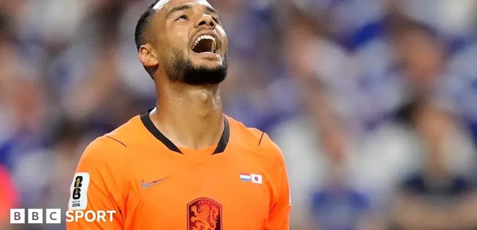 Player in orange jersey looking up during match