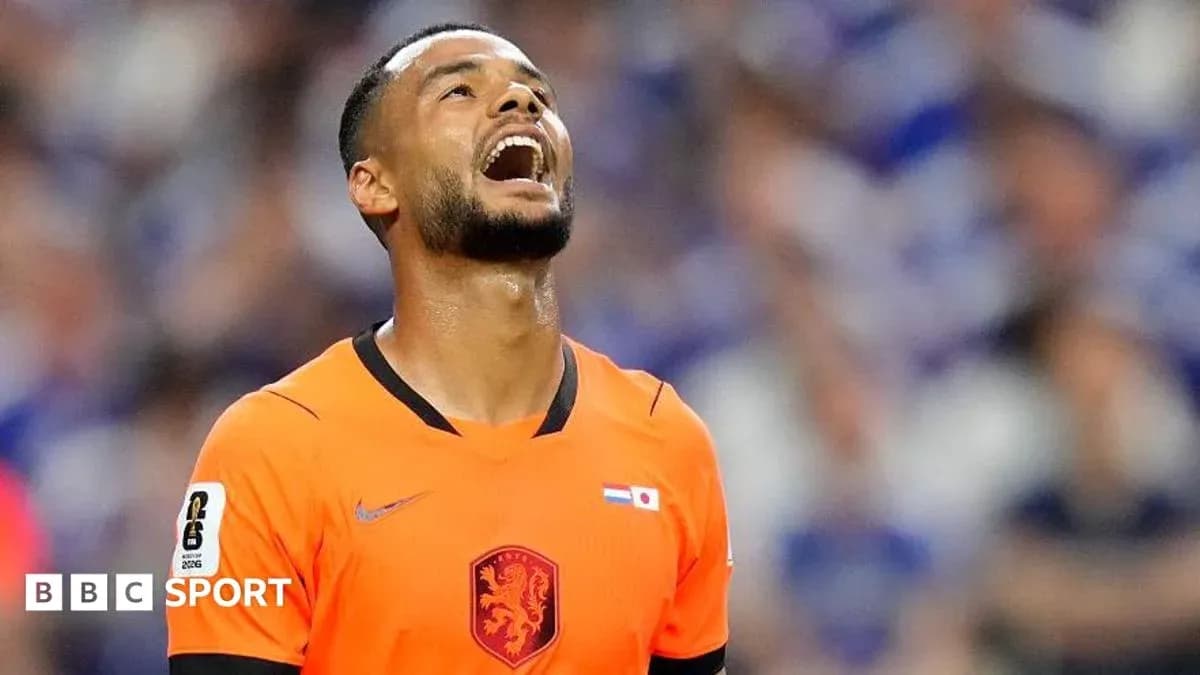 Player in orange jersey looking up during match