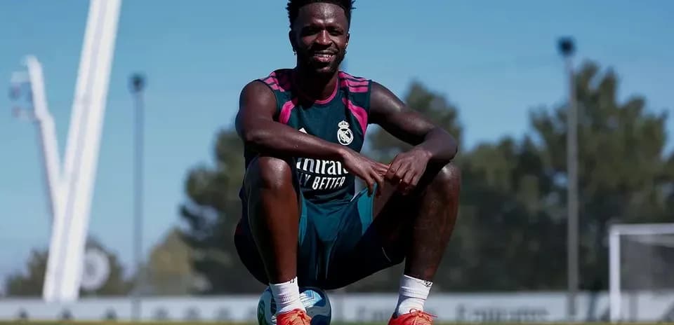 Player sitting on soccer ball during training session