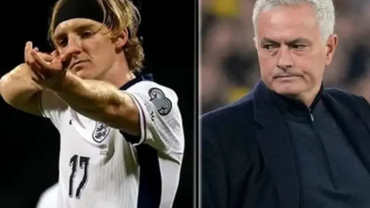 Football player celebrating and coach observing match