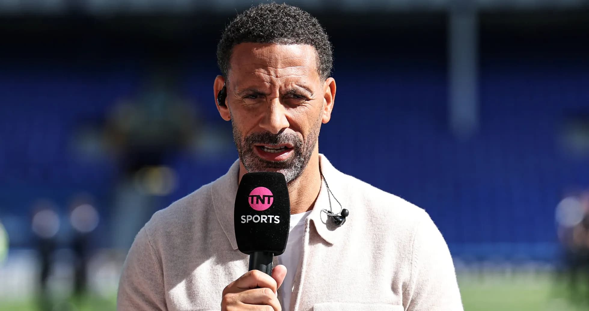 Sport analyst speaking into microphone on set