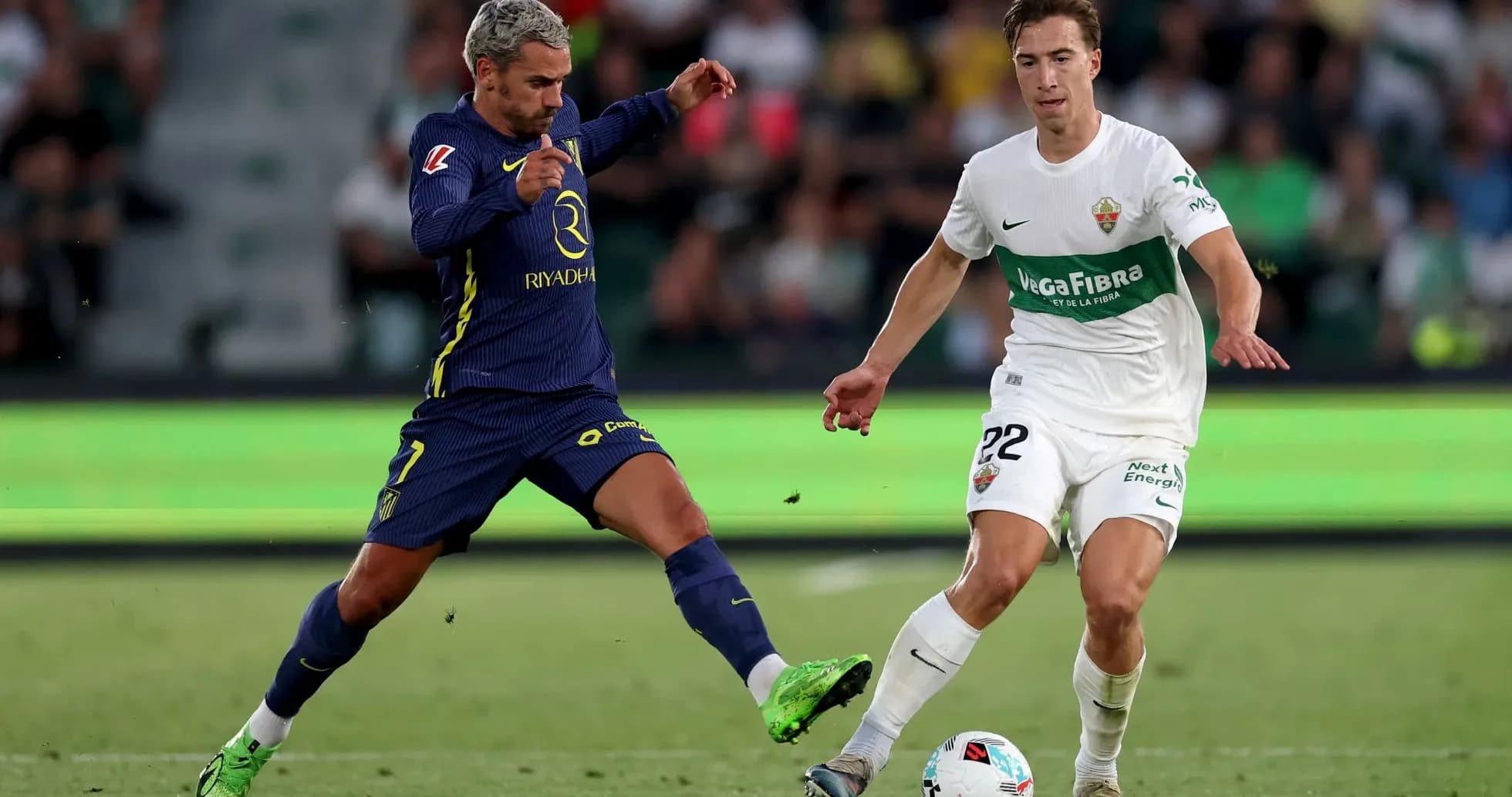 Players competing for the ball during Elche match