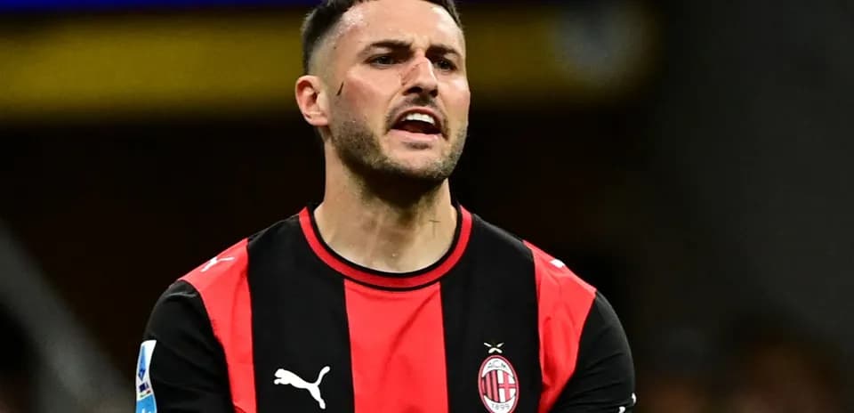 Player in AC Milan kit reacting during match