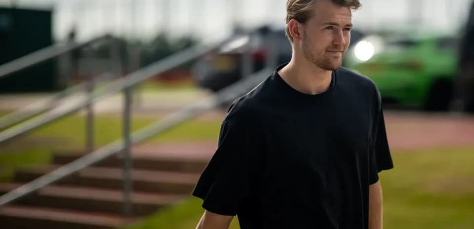 Player walking towards training facility in casual attire