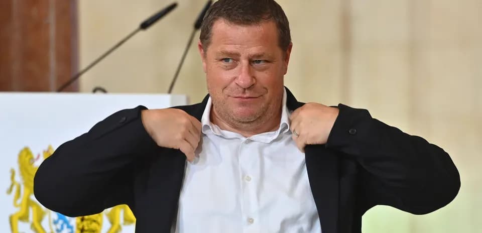 Man adjusting his jacket at a podium