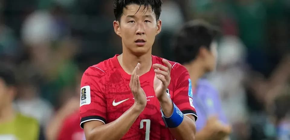 Player applauding after the match in red jersey