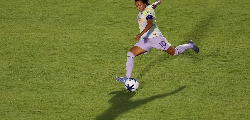 Player kicking the ball during match action