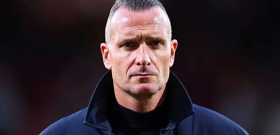 Coach standing on the sidelines during a match