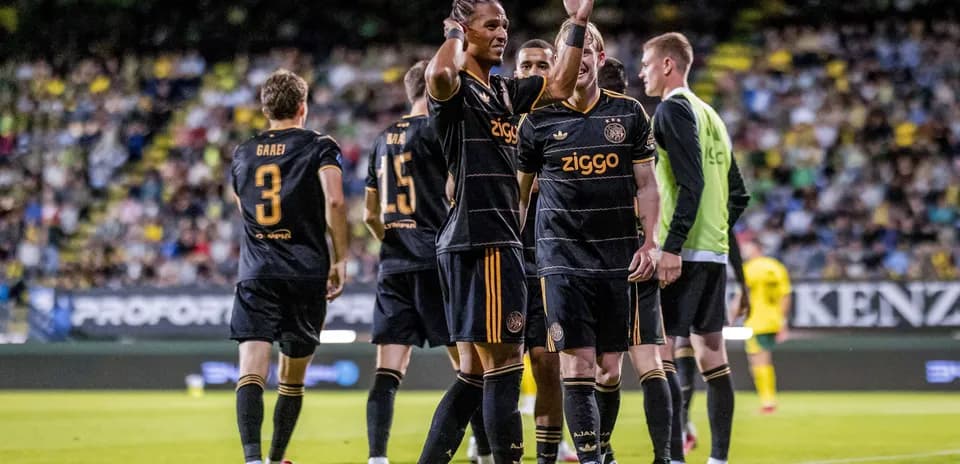 Ajax players celebrating a goal on the field