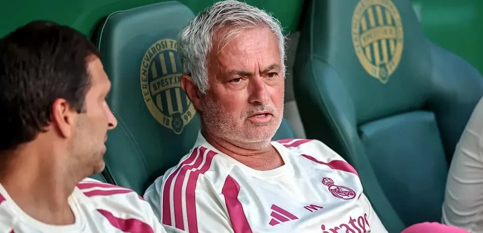 Manager and player sitting on team bench