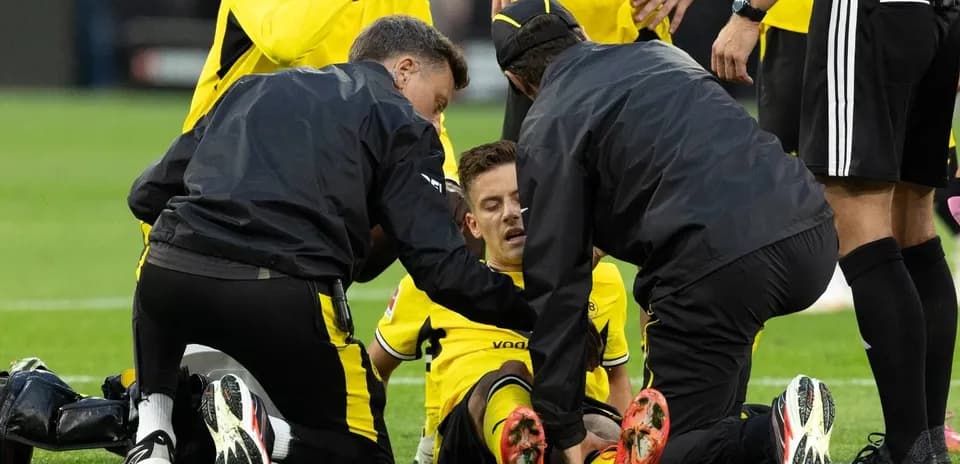 Medical staff attending to injured player on field