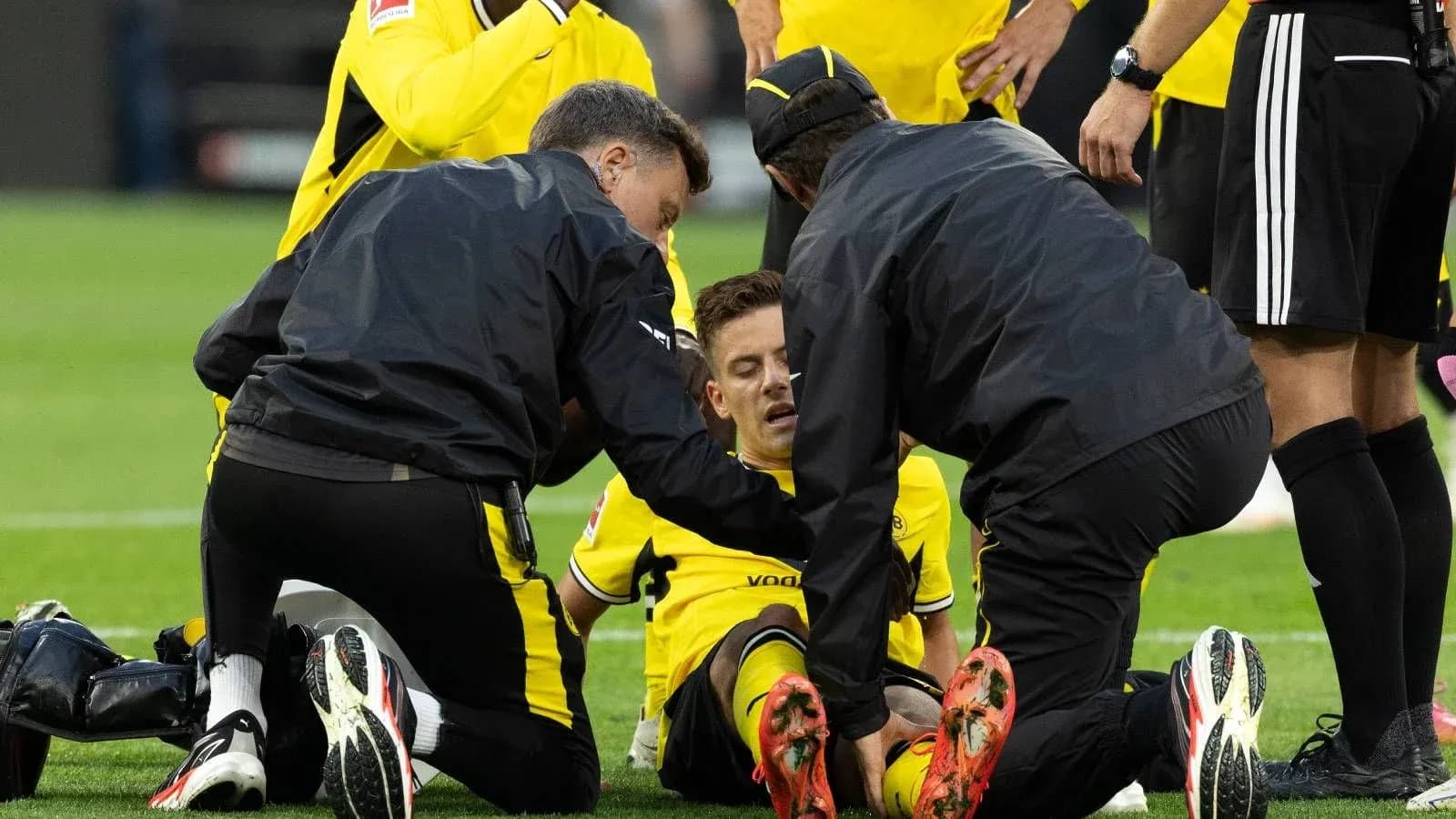 Medical staff attending to injured player on field