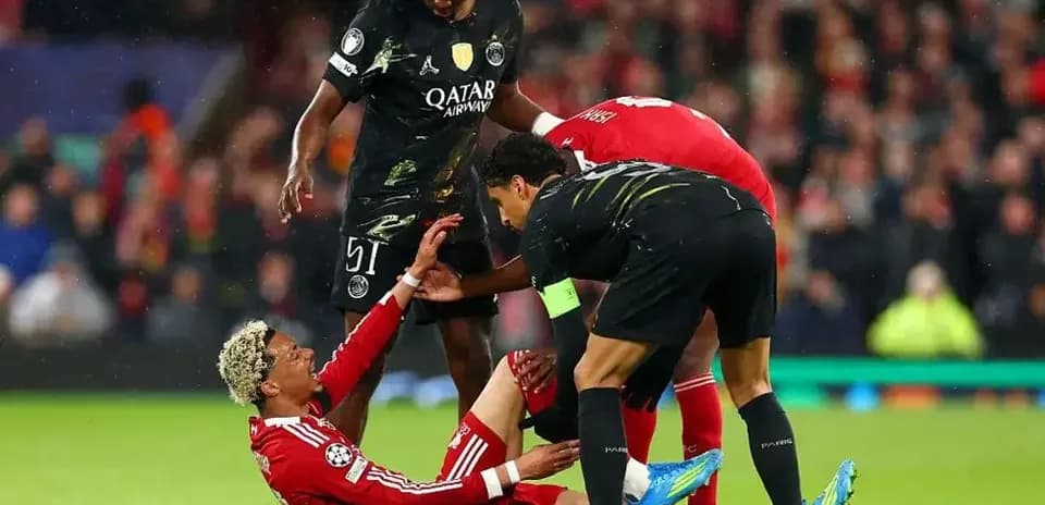 Players assisting injured teammate on the pitch
