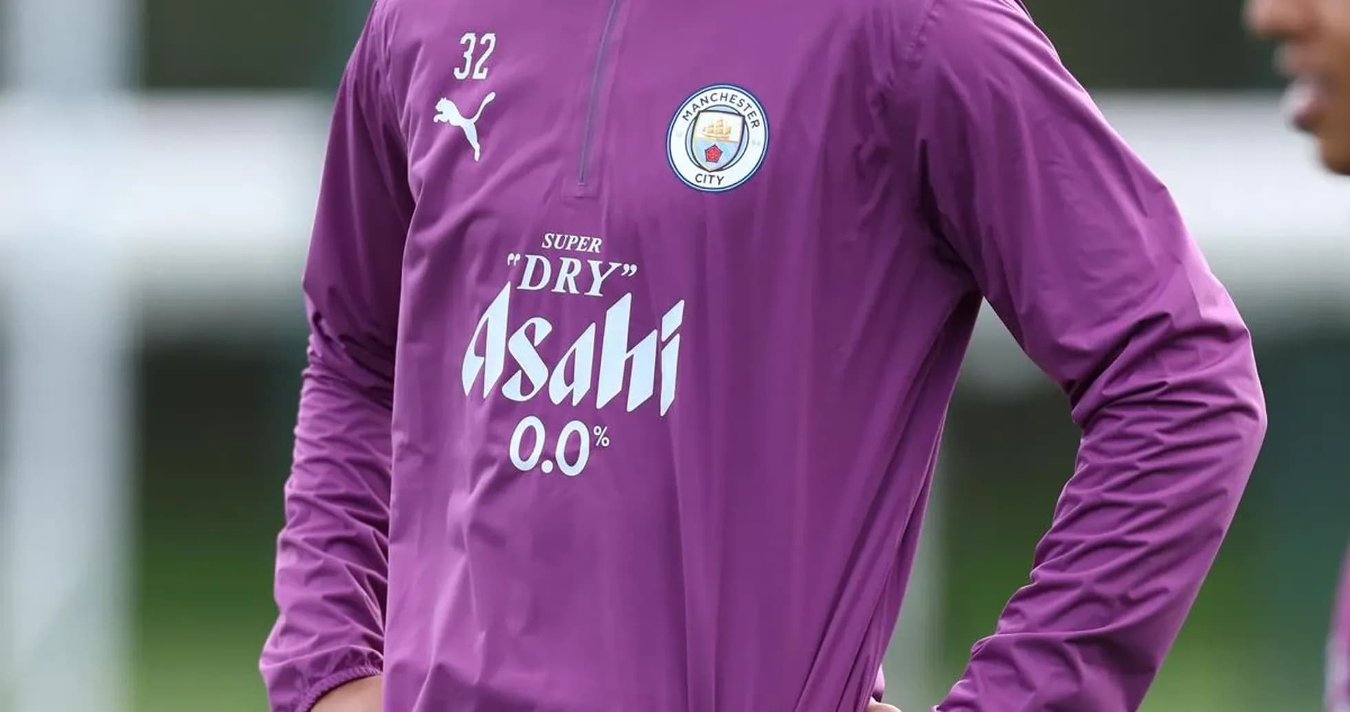 Player in Manchester City training gear on pitch