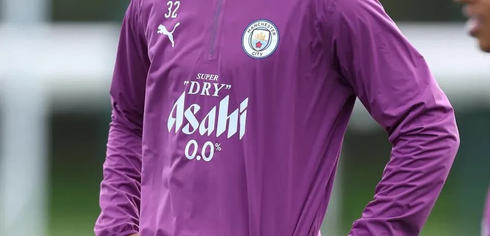 Player in Manchester City training gear on pitch