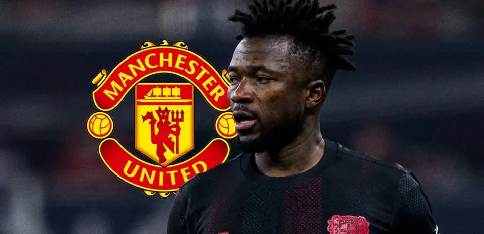 Player in black kit with Manchester United logo background