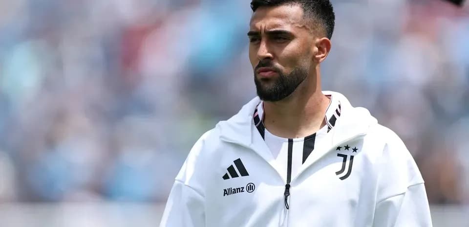 Juventus player in warm-up jacket on field