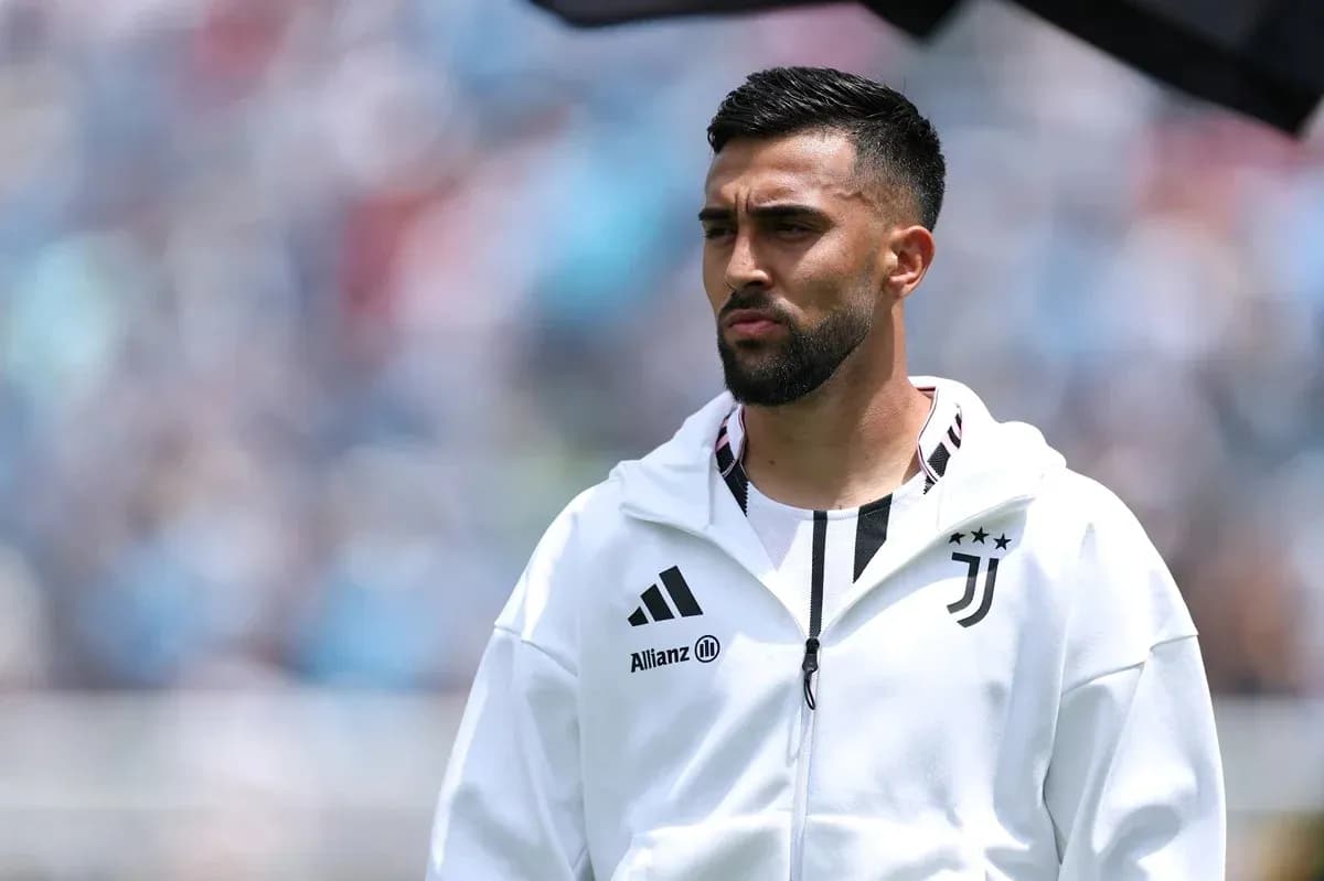 Juventus player in warm-up jacket on field