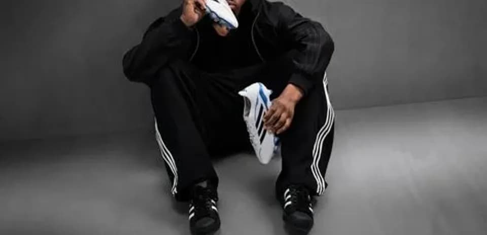 Athlete sitting with soccer shoe in hand