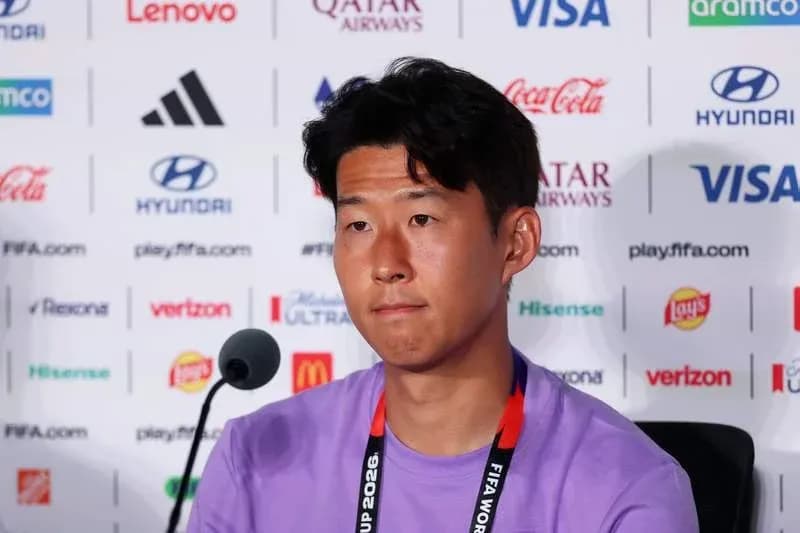 Player at press conference with sponsor logos in background